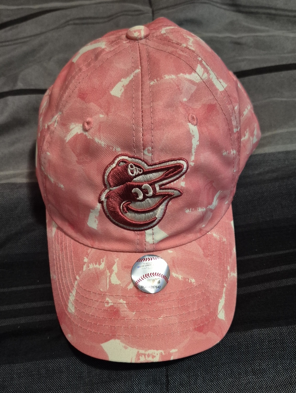 The Baltimore Orioles Genuine Merchandise Fan Favorite Adjustable Hat for women.